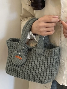 Handmade chunky knit shoulder bag in dark grey with a heart charm for casual wear