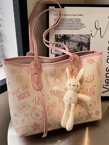 Minimalist large tote bag with pink graffiti print and a cute plush bunny pendant