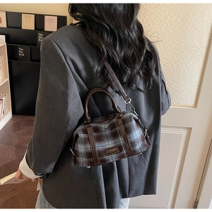 Retro plaid Boston bag shown as a crossbody purse in a vintage bookstore setting