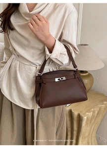 Detail of dark brown lychee textured leather and silver twist lock on the mini bag