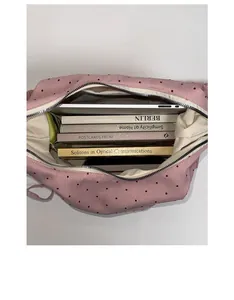 Top view of pink polka dot tote bag showing large interior capacity with laptop and books