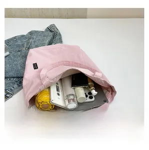 Pink canvas tote bag interior showing large capacity for tablet and daily items