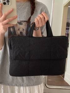 Chic black quilted laptop handbag with solid color minimalist design for women's daily commute