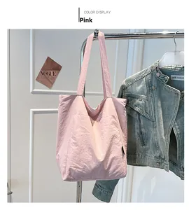 Detailed close-up of pink canvas tote bag showing soft texture and shoulder straps