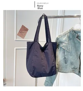 Detail view of large dark blue tote bag made of high-quality crinkled nylon fabric