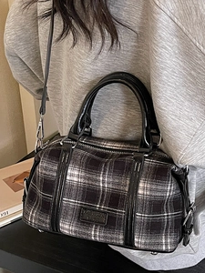 Retro black and white checkered Boston handbag with leather handles and crossbody strap
