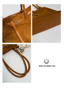 Detail view of brown suede tote bag featuring silver metal buckle and reinforced leather bottom