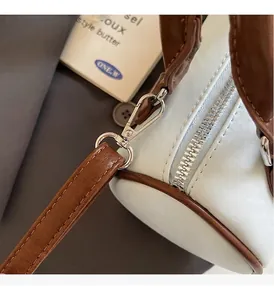Detail of high-gloss silver hardware and zipper on a retro boston leather handbag