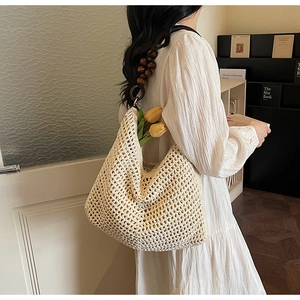 Detail of crochet tote bag with wooden bead strap and net hollow texture