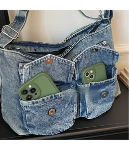 Detail of vintage denim tote bag featuring functional front pockets and metal buttons