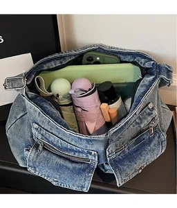 Deep blue denim tote bag detail showing large capacity with umbrella and daily items