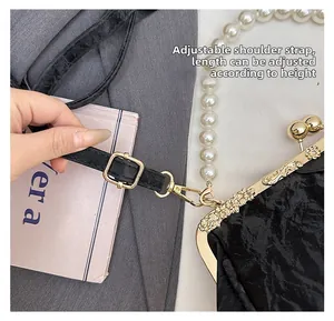 Detail of beaded shell bag with gold engraved clasp and adjustable leather strap