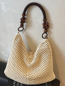 Beige crochet woven tote bag with dark brown wood beads and nautical rope handle