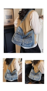 Detail of vintage blue denim tote bag featuring dual front utility pockets and metal buckles