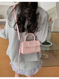 Pink minimalist crossbody bag with square buckle and smooth matte finish for women