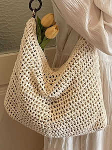 Chic beige crochet tote bag with round wood handles for summer beach vacations
