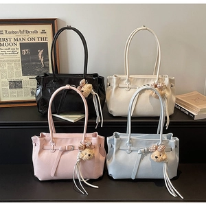Detailed display of tote bags in four colors with cute bear charms and leather tassels