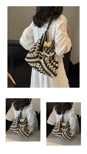 Detail of woven tote bag with pearl chain strap and chic geometric floral pattern
