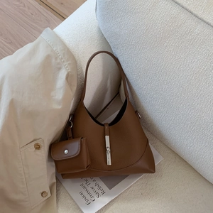 Close-up of brown lychee grain leather hobo bag with silver buckle and mini pouch