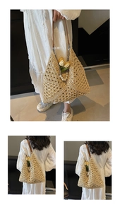 Detailed close-up of woven straw tote bag with pearl chain and leather shoulder straps