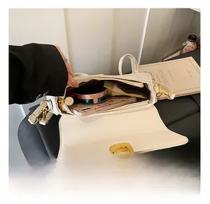 Internal view showing the spacious white PU leather bag with cosmetics and phone