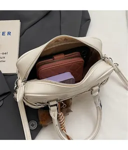 Interior view of off-white bowling bag showing storage capacity for phone and wallet