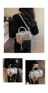 Detail view of silver metallic Boston bag featuring a brown pony plush pendant accessory