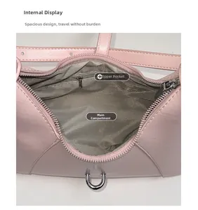 Pink leather shoulder bag internal view with herringbone lining and zippered pocket
