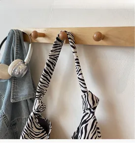 Close-up of zebra pattern canvas bag with stylish knotted handle and durable fabric