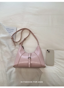 Detail of pink PU leather underarm bag with adjustable strap and decorative buckle