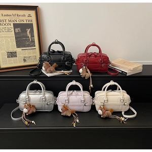 Detail showing five colored bowling bags with horse charms and adjustable straps