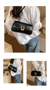 Detail view of black square shoulder bag with smooth finish and gold metallic buckle
