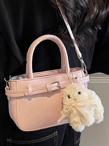 Pink minimalist PU leather handbag with decorative buckle and a cute plush rabbit charm