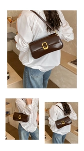 Detail view showing a brown leather underarm bag with a large golden buckle on a white shirt