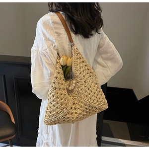 Detail of bohemian woven hobo bag with pearl charm and premium leather strap