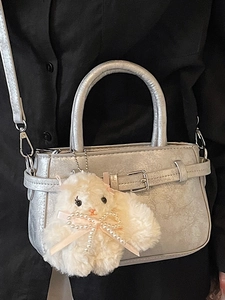 Silver textured mini crossbody bag with top handle and plush bunny pendant detail