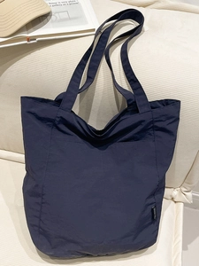 Minimalist large navy blue nylon tote bag for women featuring stylish stitch details