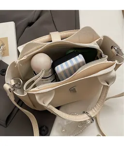 Top view of cream bucket bag showing large interior space for folding umbrella and makeup