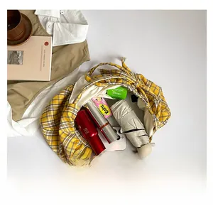 Detail shot of yellow checkered tote bag showing large capacity for daily essentials