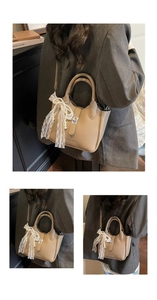 Close-up of brown textured leather bucket bag with lace bow and pearl pendant details