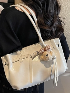 Chic white patent leather tote bag with long straps and cute brown bear pendant