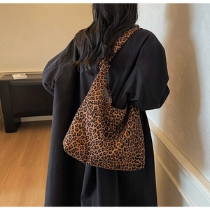 Detail of leopard print canvas tote bag with unique knotted shoulder strap design
