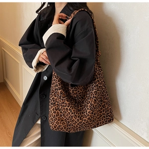 Macro view of leopard print texture and spacious structure on large shoulder bag