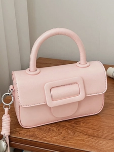 Chic pink square handbag with top handle and large buckle for crossbody style