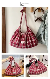 Detail of red and white plaid tote bag featuring a pleated texture and casual canvas label