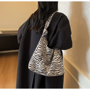 Detail of soft zebra print canvas tote bag with a stylish knotted shoulder strap design