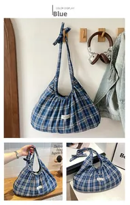 Detail view of the blue checkered tote bag with pleated fabric and a knotted strap design