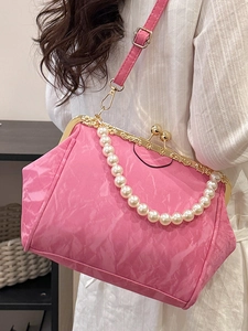 Chic pink pleated cloud bag with pearl handle and golden clasp for stylish women