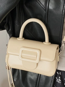 Elegant beige leather square handbag with iconic buckle and adjustable shoulder strap