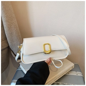 Detail of white square shoulder bag featuring gold metallic clasp and matte leather texture